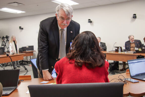 Harold McKinney listens to a fellow Kentucky Board of Education Member during a board meeting.