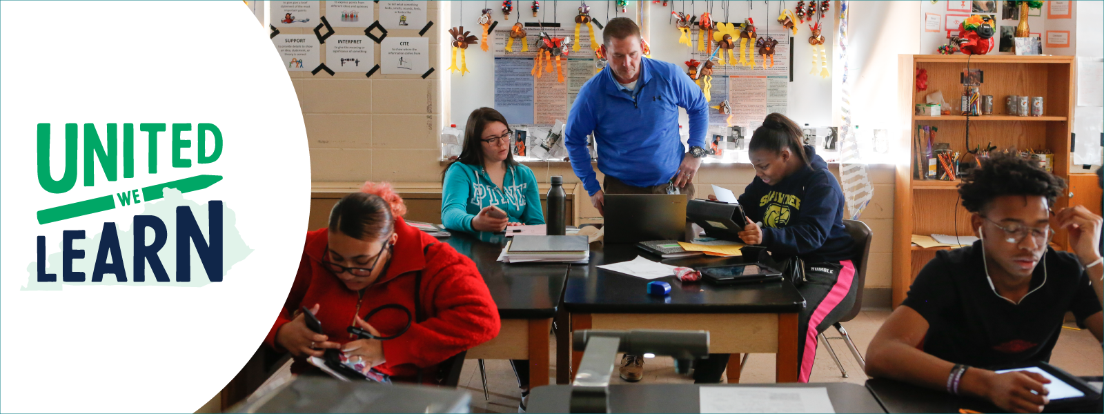 teacher teaching to the students in a class