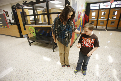 A teacher with a student in the hallway