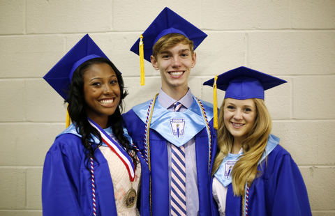3 students in graduation dresses