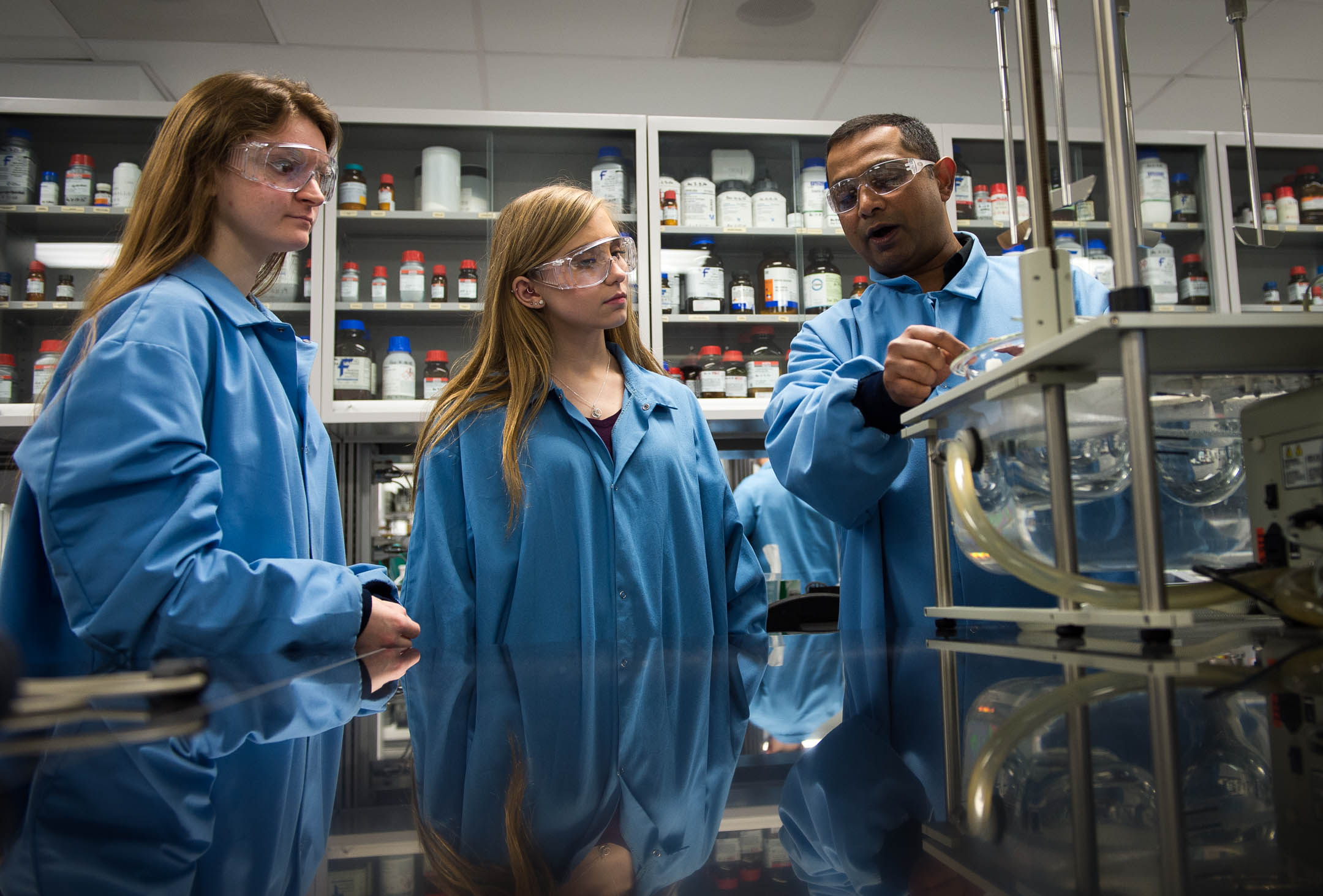 Students working with teacher in lab