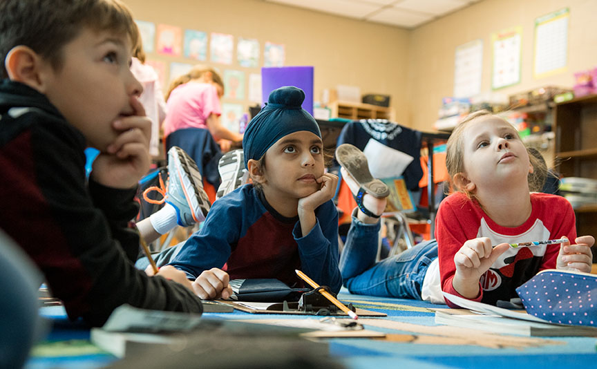 A group of students listening