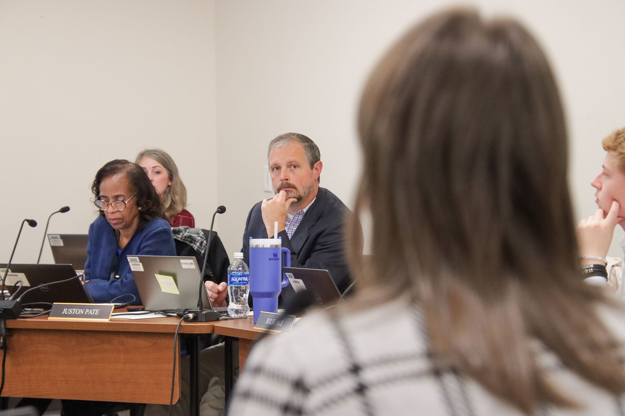 Kentucky Board of Education members listen to a presentation while seated at a board meeting.