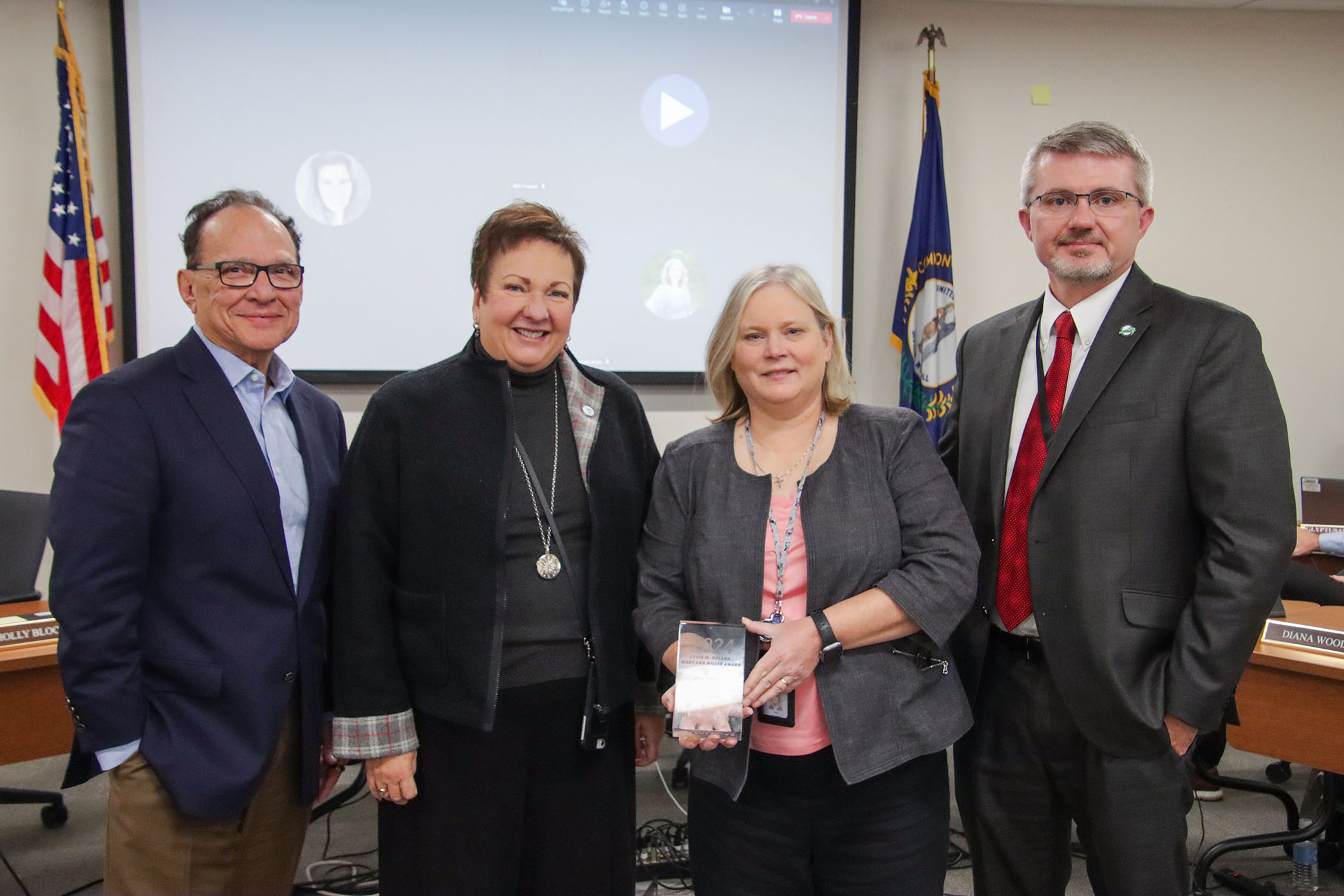 Ed Miller, Lu Young, Amy Patterson and Commissioner of Education Robbie Fletcher pose with an award.