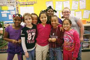 A group of students posing for a picture in a classroom